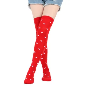 Red over-the-knee socks featuring a white heart pattern for Valentine's Day party
