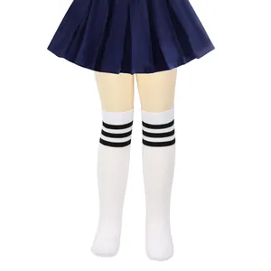Close-up of girls' white knee-high socks with three black stripes and navy pleated skirt