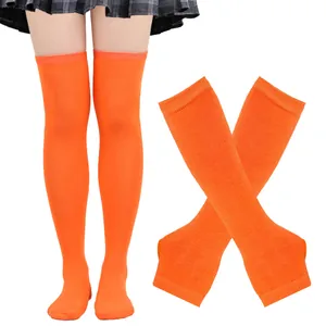 Detailed view of bright orange thigh-high stockings and matching fingerless gloves set.