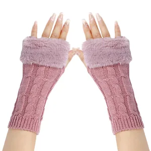 Detailed view of pink cable knit texture and faux fur trim on fingerless gloves