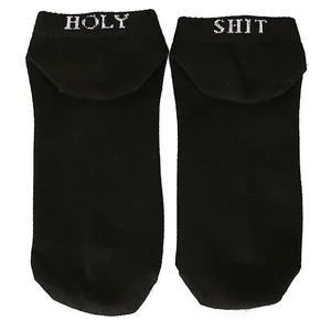Detailed view of black funny socks featuring 'HOLY SHIT' printed design on the heel