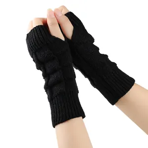 Detailed view of black knitted fingerless gloves for women, warm wool texture display.