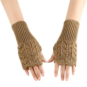 Detailed view of brown knitted fingerless gloves with hollow heart pattern for winter