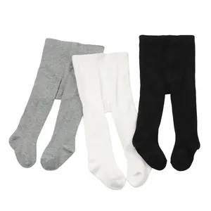 Three pairs of soft cotton baby footed leggings in solid grey, white, and black colors.