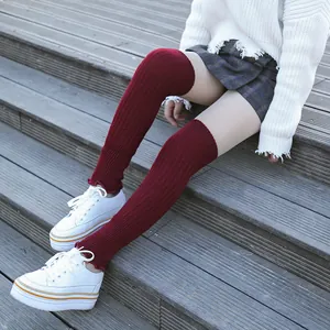 Detail view of burgundy knitted over-the-knee leg warmers for yoga, ballet or daily wear