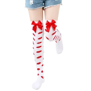 Detailed view of white thigh-high socks featuring red lip prints and satin bows.