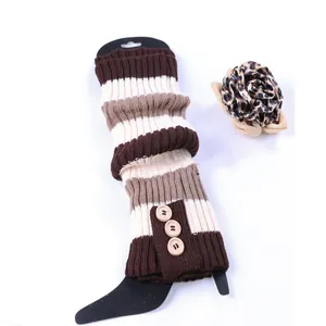 Detailed macro view of striped knit leg warmers featuring three vintage wooden buttons