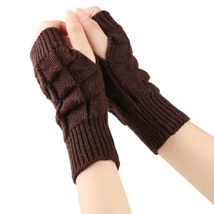 Detailed macro view of dark brown knitted fingerless gloves with textured basket-weave pattern