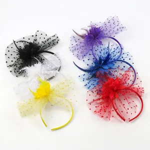 Close-up of multi-colored mesh fascinator headbands with flower and feather details