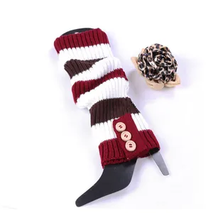 Detailed view of striped knitted leg warmers with three decorative wooden buttons.