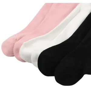 Detailed texture of soft ribbed infant footed tights in pink white and black