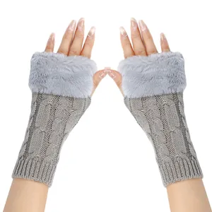 A close-up detail view of grey cable-knit fingerless gloves with soft faux fur trim for winter