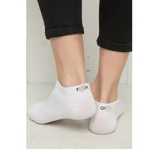 Close-up of white cotton ankle socks with parody English text on the back of the heel