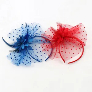 Detail of vintage fascinator headbands with blue and red polka dot mesh and feathers