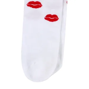 Detailed close-up of white over-the-knee socks featuring vibrant red lip print patterns
