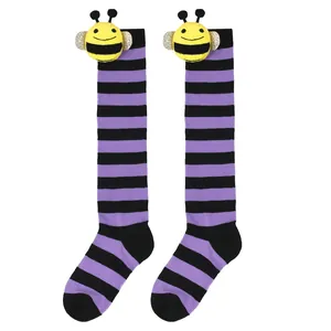 Close-up of cute 3D bee doll detail on purple and black striped children knee-high socks