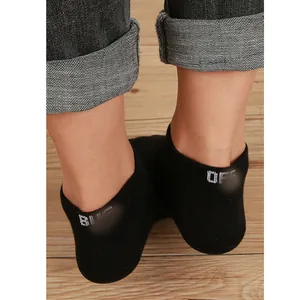 Detailed view of black ankle socks with white letter embroidery on the heel section.