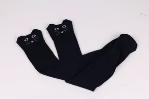 Detailed view of navy blue over-the-knee socks with cute embroidered cat face design