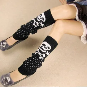 Black knitted leg warmers with white skull and polka dot pattern for Halloween