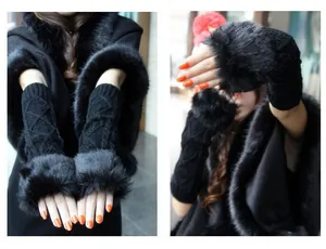 Detail view of black knit arm warmers featuring plush faux fur trim and diamond patterns.