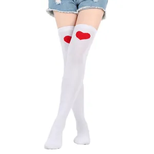 Detail view of white thigh-high over-the-knee socks with red heart motif