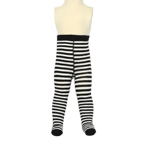 Close-up view of black and white striped footed tights for infants on a mannequin