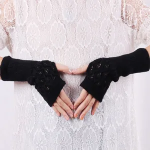 Elegant black knitted long fingerless gloves with hollow-out pattern on white lace
