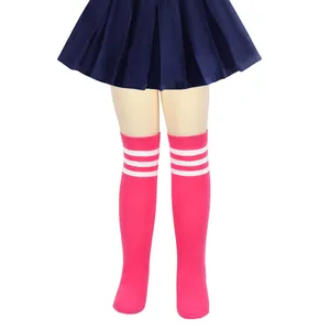 Detailed view of girls pink knee-high socks with three white stripes and pleated skirt