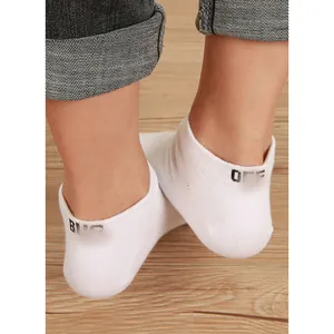 Detailed view of white cotton ankle socks with black letter print on the heel area