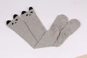 Detail view of gray over-the-knee socks with cute panda ears and face design
