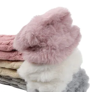 Close-up of soft cable knit arm warmers with thick faux fur trim in multiple colors.