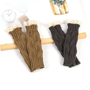 Close-up of knitted arm warmers with leaf pattern and lace trim in brown and grey.