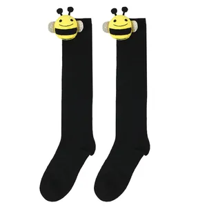 Cute children's black knee-high socks featuring a 3D plush bee doll attachment
