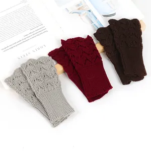 Detail view of heart-patterned knitted fingerless gloves in grey, red, and brown colors