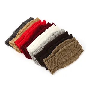 Detail view of knitted fingerless gloves in various colors with soft textures.
