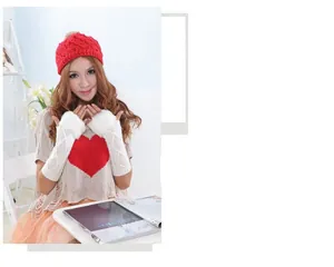 Detail view of long knitted fingerless arm warmers with white faux fur trim on model