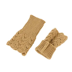 Detailed macro view showing heart-shaped knit pattern on camel fingerless arm warmers