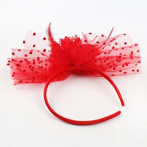 Detail showing red vintage fascinator headband with feathers and polka dot mesh netting