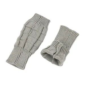 Detailed view of grey knitted fingerless gloves with cable knit texture and rib cuffs