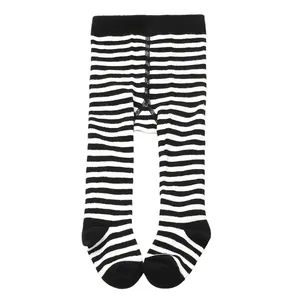 Macro view of black and white striped soft cotton footed leggings for infants