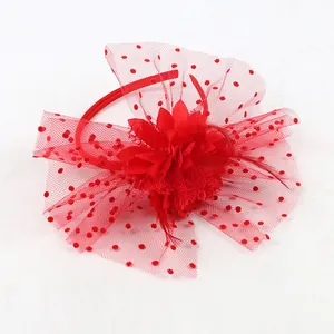 Elegant red fascinator headband with mesh veil, feathers and fabric flower detail