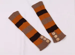 Macro view of striped knitted leg warmers with decorative wooden buttons for winter.