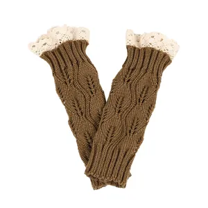 Detail of brown knitted fingerless gloves featuring leaf patterns and white lace trim