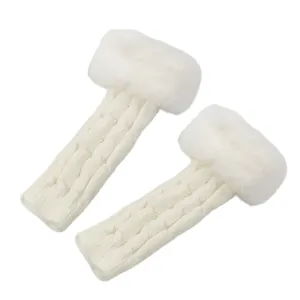 Close-up of white cable-knit fingerless gloves with fluffy faux fur trim for winter.