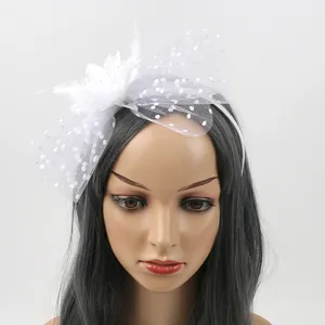 Vintage white fascinator headband with delicate mesh veil, feathers, and floral accents