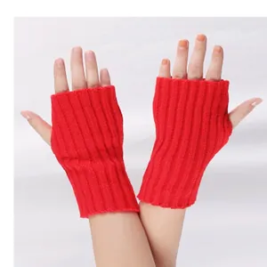 Close-up of red knitted fingerless arm warmers showing texture and fit on hands