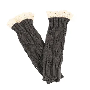 Close-up of charcoal knitted wrist warmers with lace trim and leaf pattern