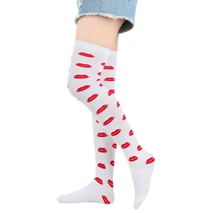 Close-up of white over-the-knee socks featuring a vibrant red lip print pattern