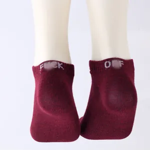 Detailed view of maroon ankle socks featuring a knitted 'Fuck Off' prank slogan on heels
