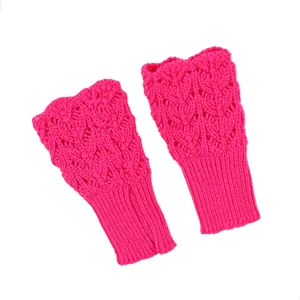 Detailed macro shot of fuchsia pink knitted fingerless gloves with heart crochet pattern